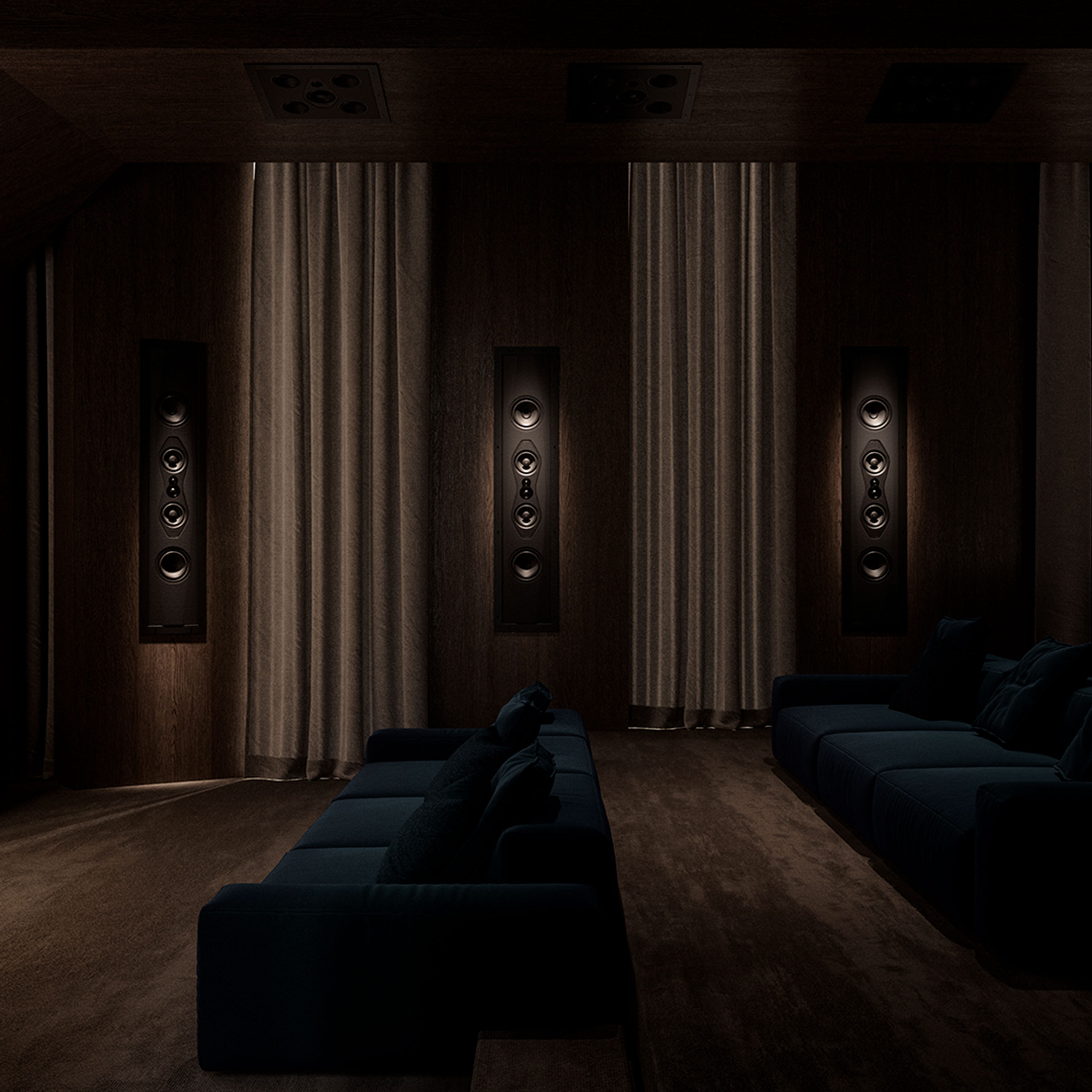 A home theater space with staggered seating, featuring custom-installed Sonus faber Arena Collection speakers.