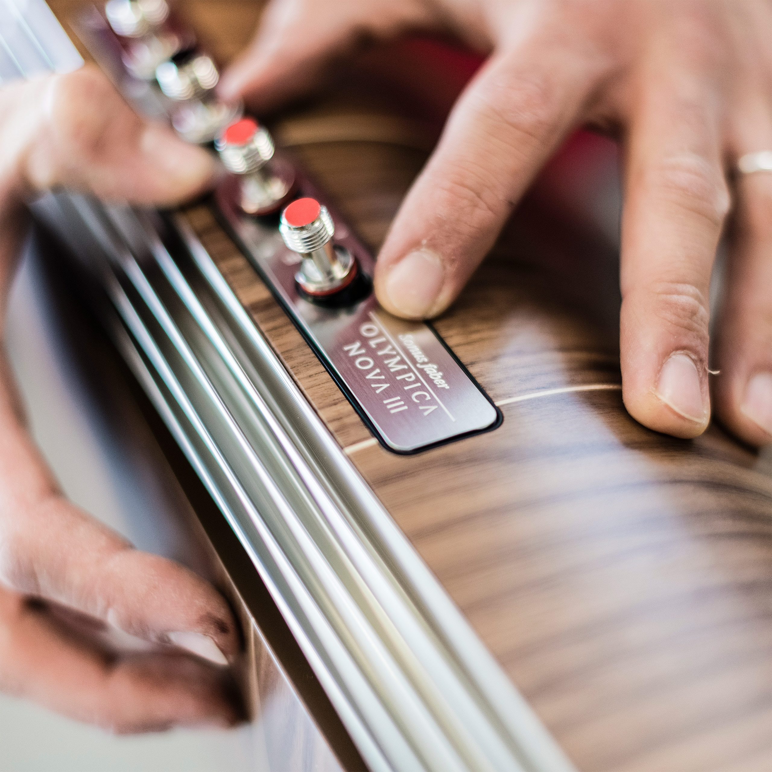 Italian artisan handcrafting the Sonus faber Olympica Nova III floorstanding speaker, showcasing meticulous craftsmanship.