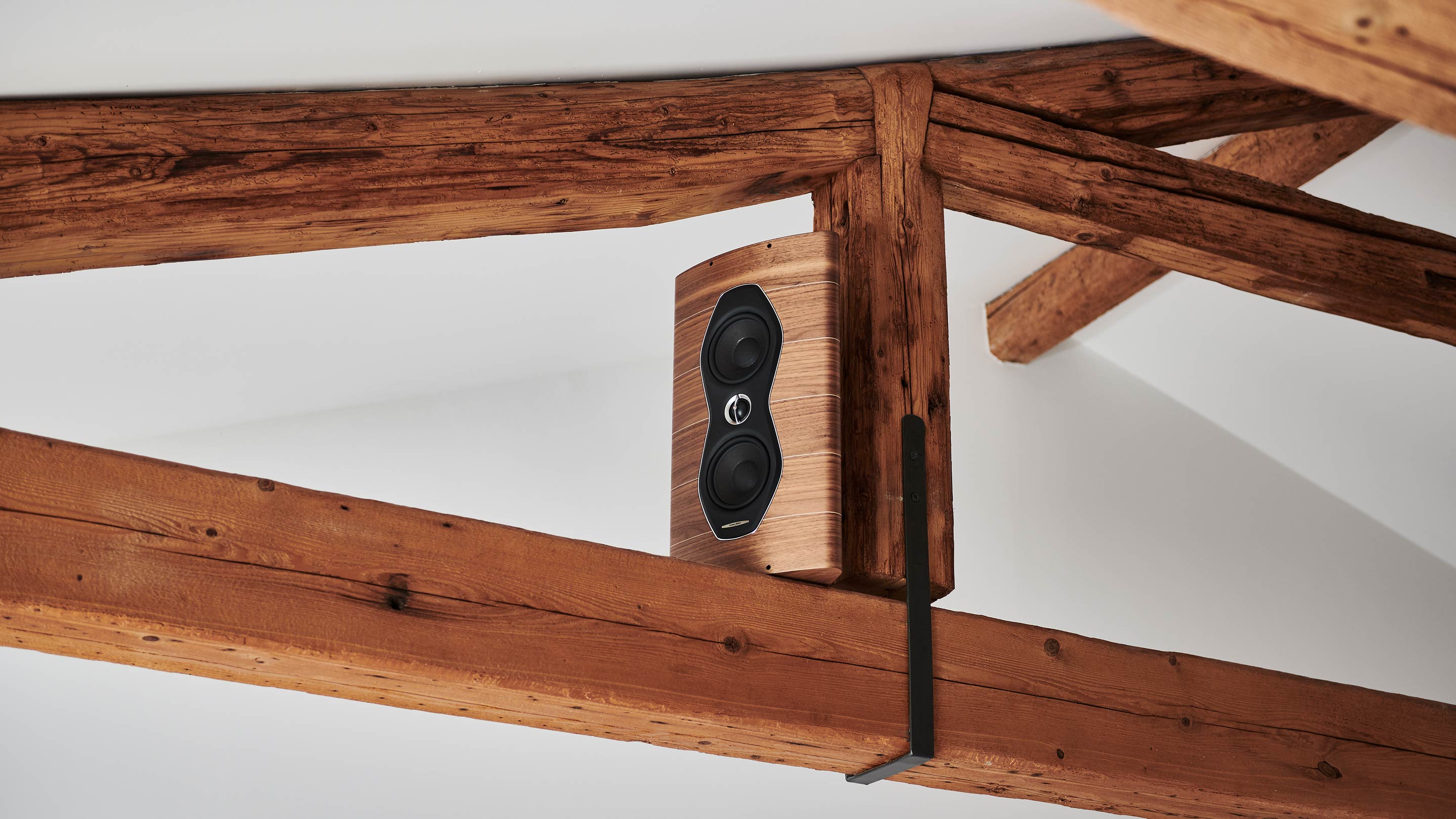 Sonus faber Olympica Nova W in Walnut Wood with Italian leather finishes seamlessly integrated into ceiling wood beams.