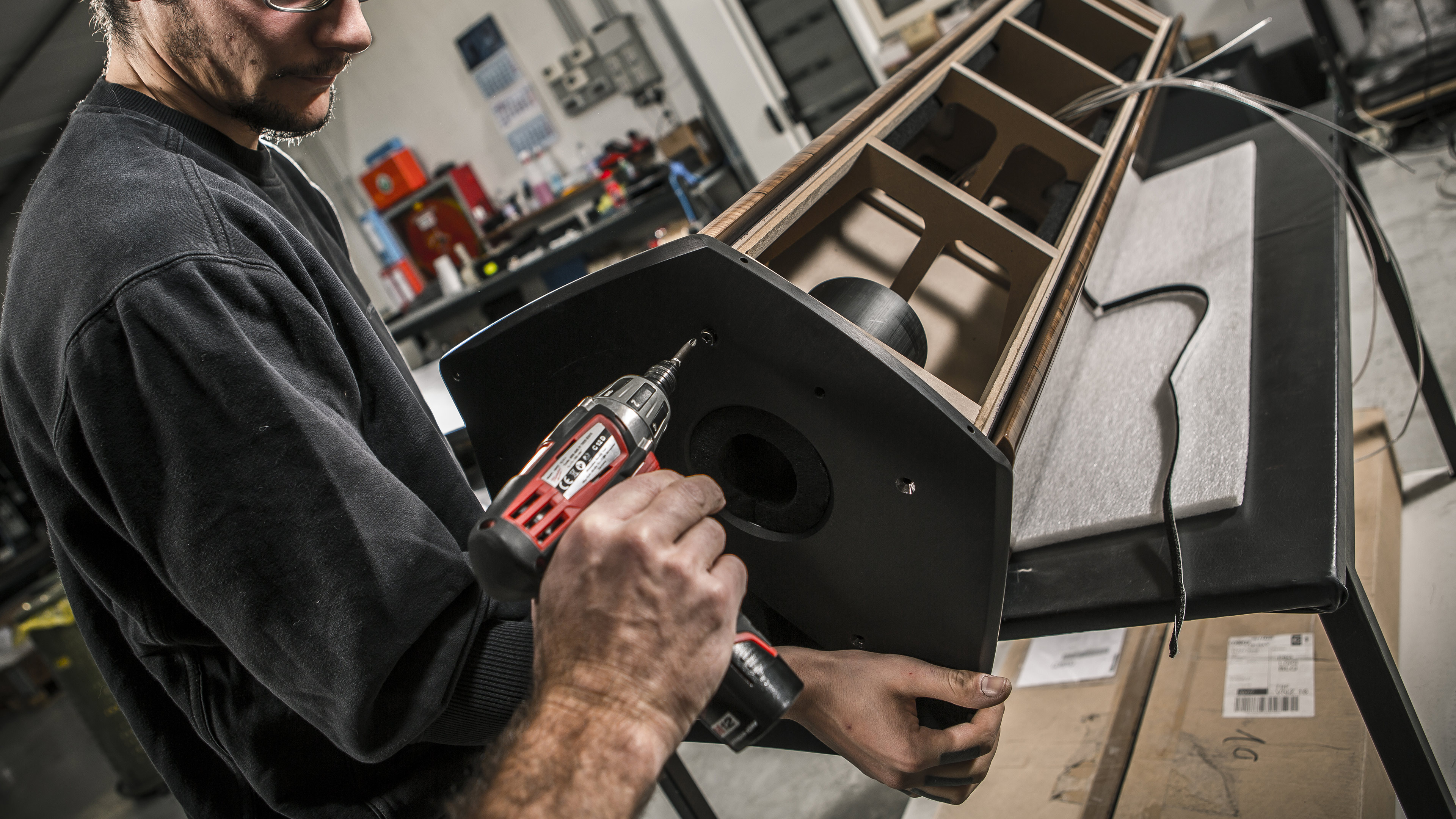 Team of Sonus faber Italian artisans meticulously hand-screwing details onto an Il Cremonese floorstanding loudspeaker.