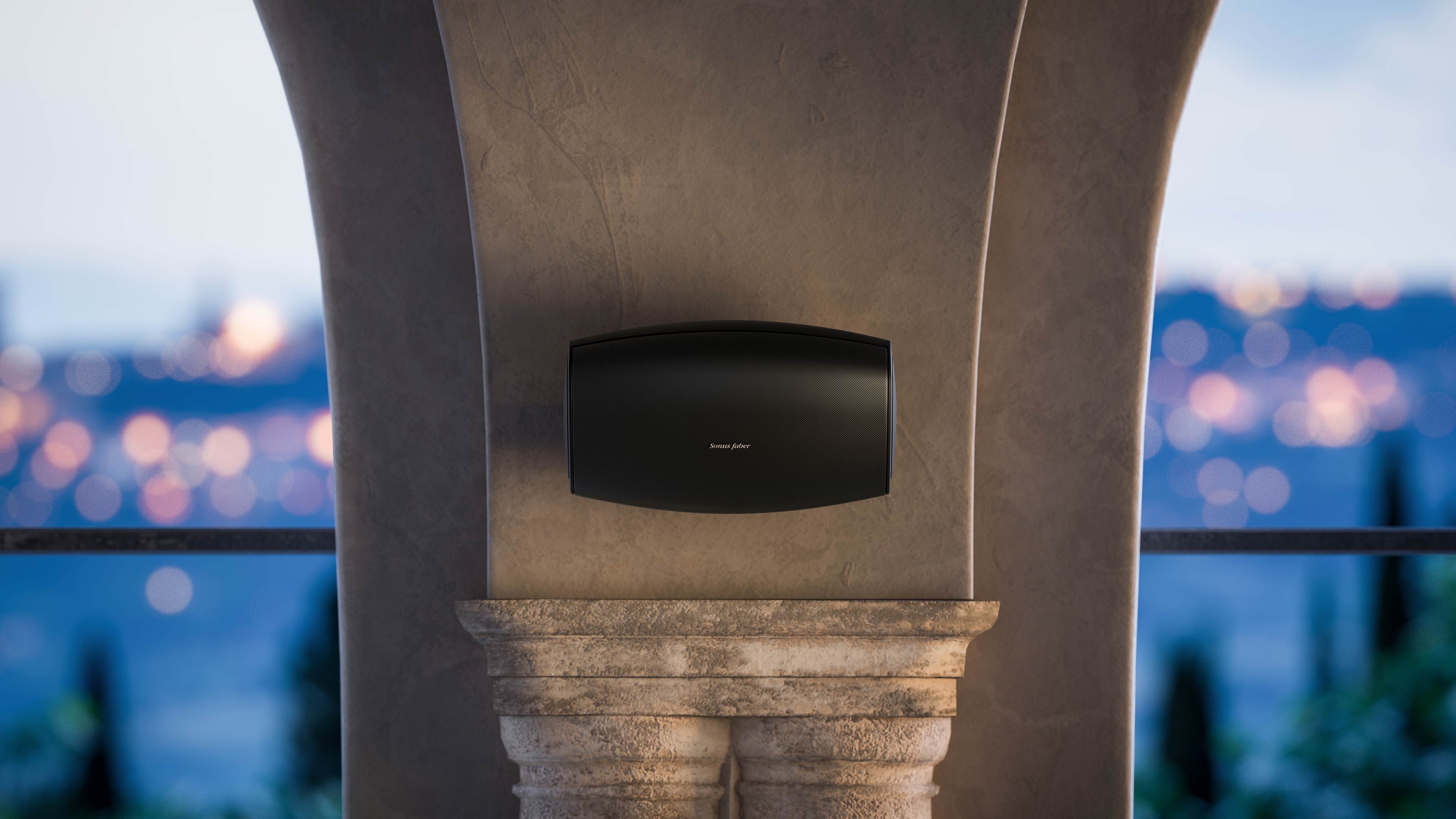 A Sonus faber Aster outdoor speaker custom-installed on an exquisite cement column in a beautiful outdoor environment