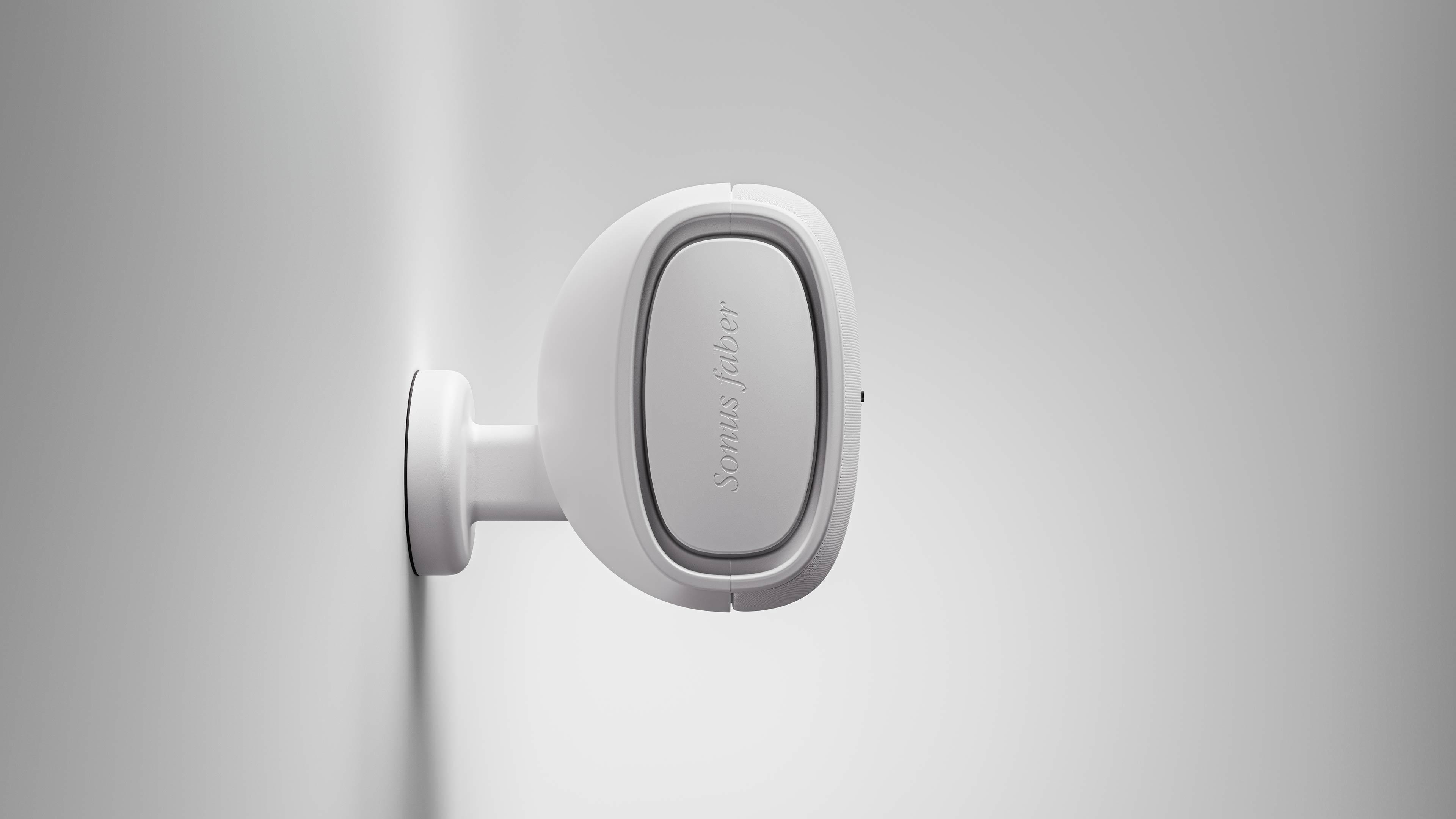 Sonus faber Aster outdoor speaker in white, mounted on a white wall, exemplifying its ability to seamlessly blend in.