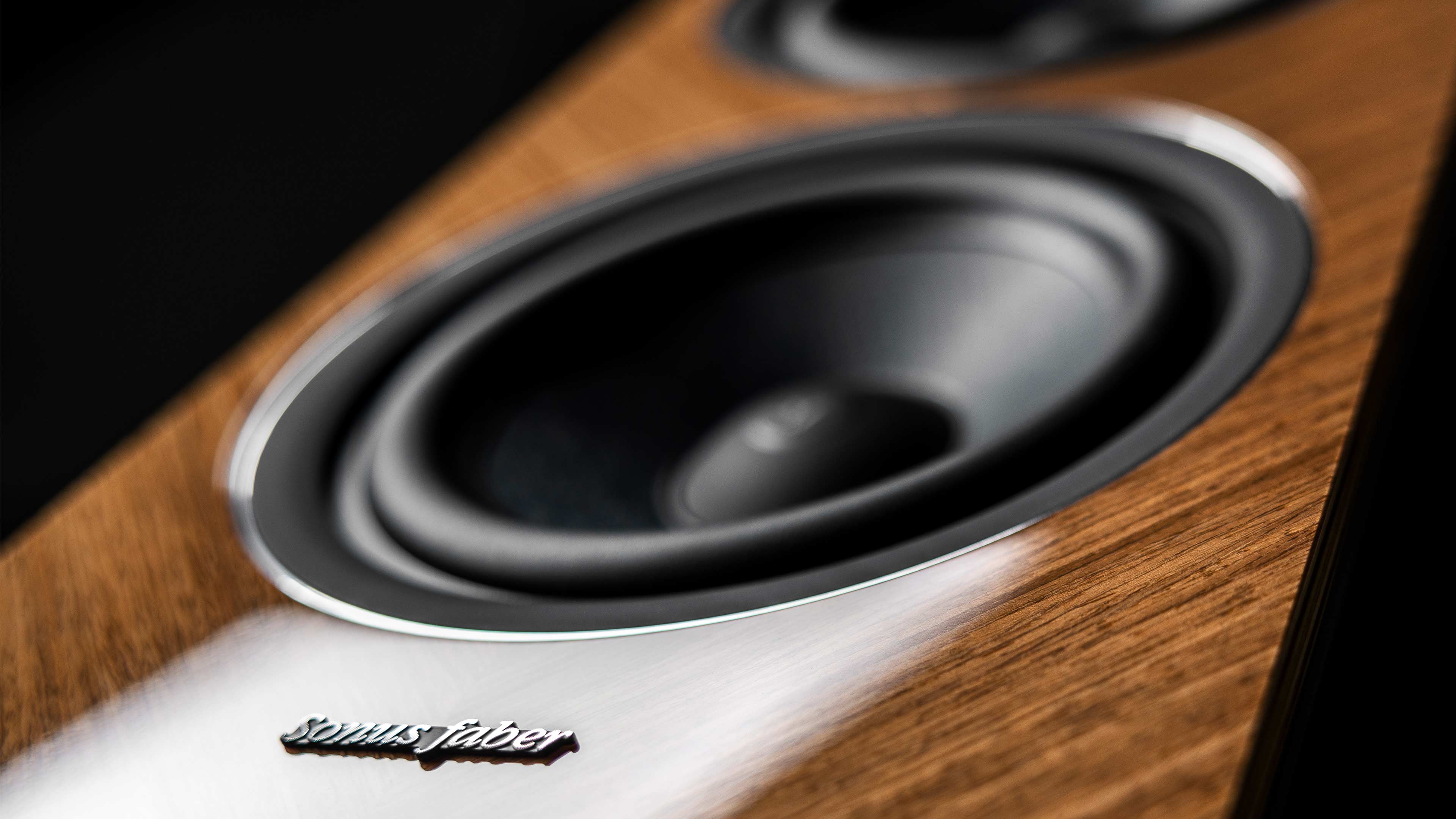 A trio of Sonus faber Lumina V Amator speakers, offered in red, wenge, and walnut high gloss finishes.