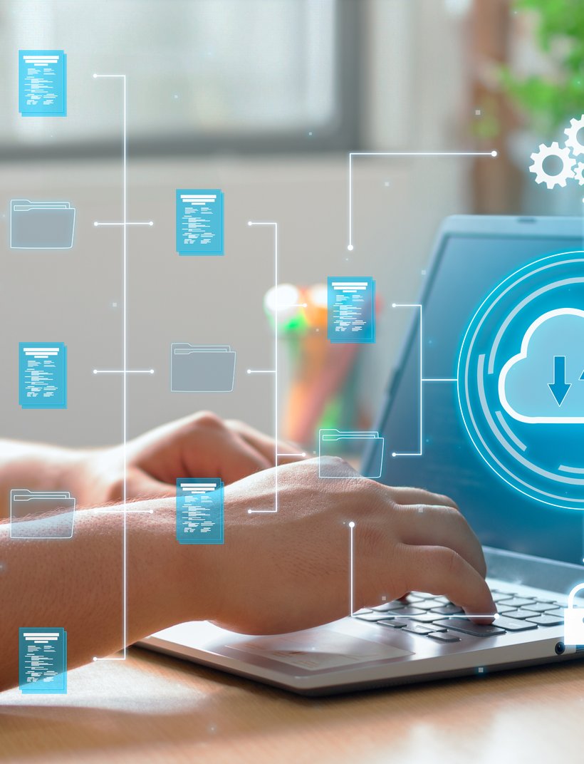 Hands typing on a laptop with digital icons of folders, a cloud, and gears, representing data storage and cloud computing.