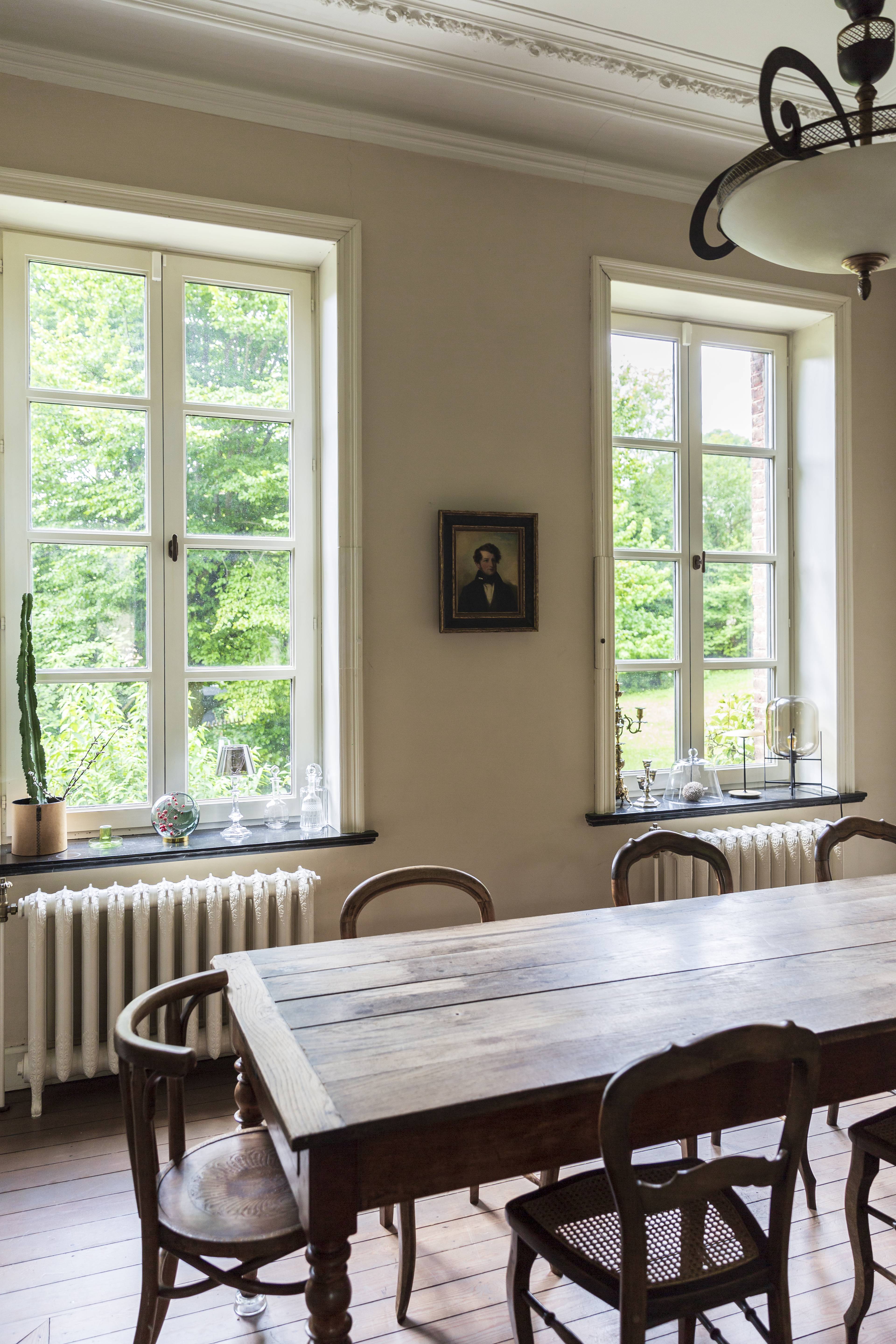 Binnenaanzicht van een klassieke woonkamer met klassieke witte houten kozijnen met kruisverdeling