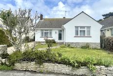White bungalow and driveway and lawn area