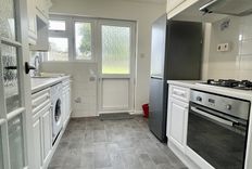 White kitchen with oven and fridge