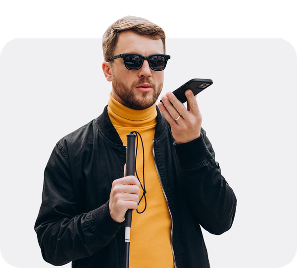 Man with sunglasses and a cane using the screen reader on his smartphone.
