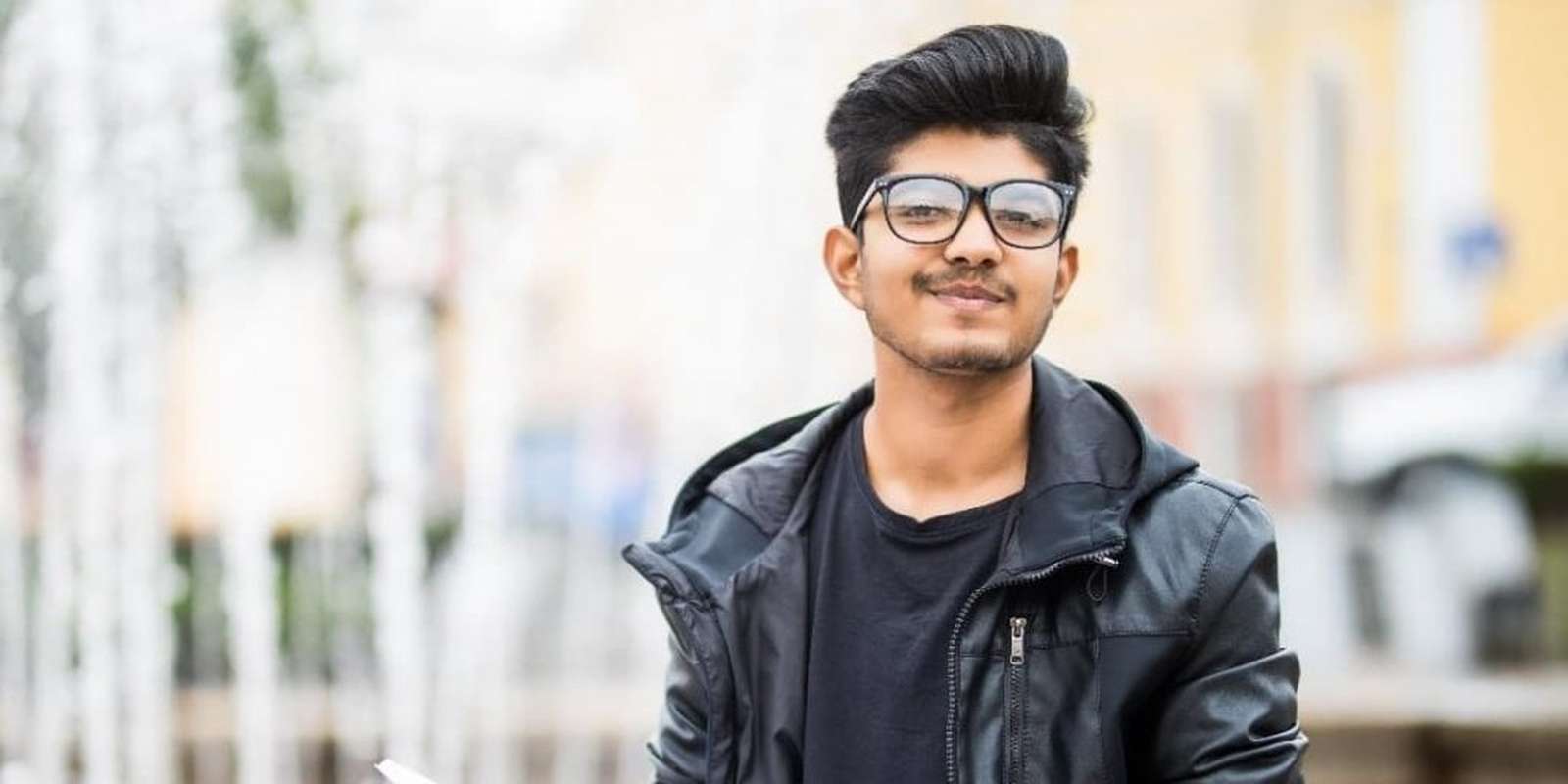 Young student apprentice with open notes/books outside