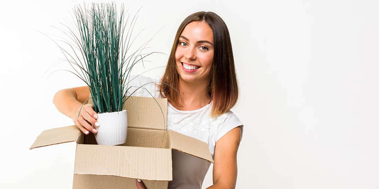Smiling woman packing items for her university stay