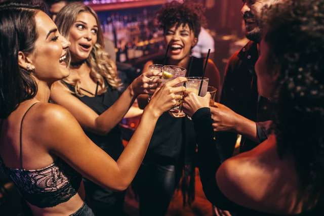 Students in the club toasting with drinks