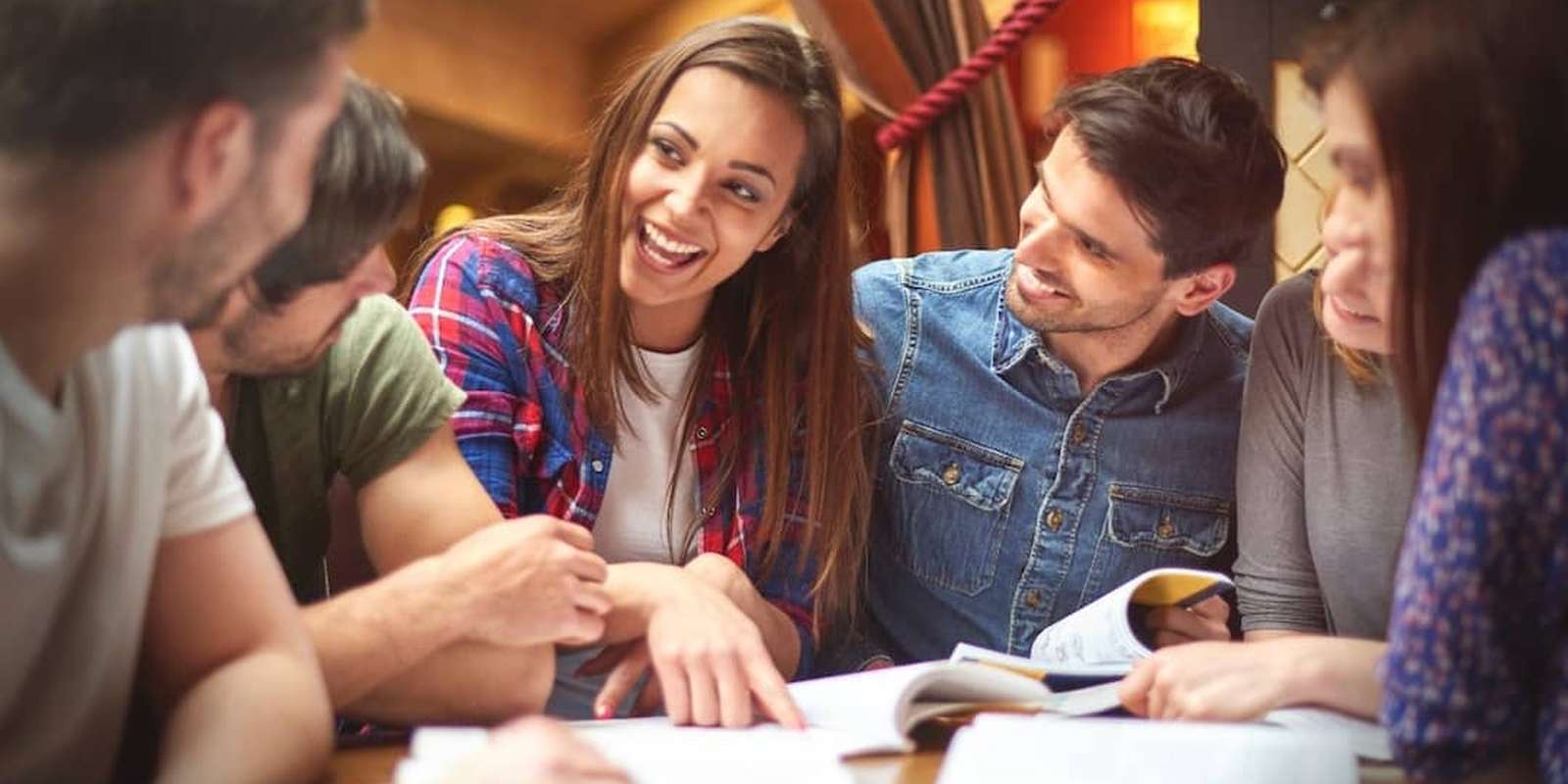Happy students studying together