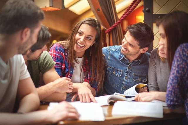 Happy students studying together