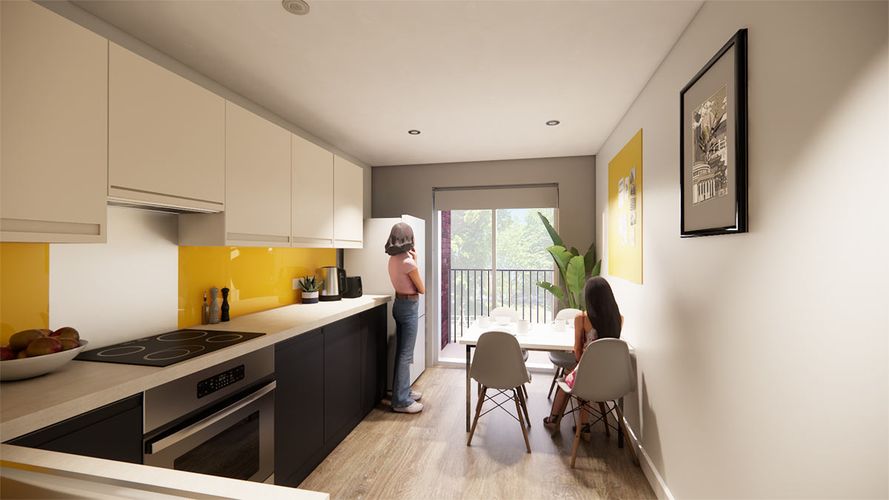 Bright modern galley kitchen with yellow backsplash and balcony; two women, one standing at the counter, one seated at the dining table.