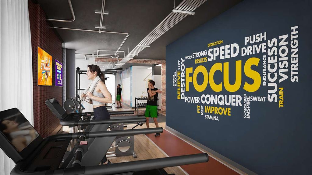 Gym interior with a motivational word cloud on the wall; woman running on a treadmill, man stretching nearby.