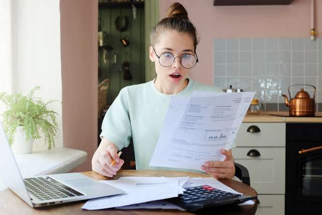 A student looking at her bills
