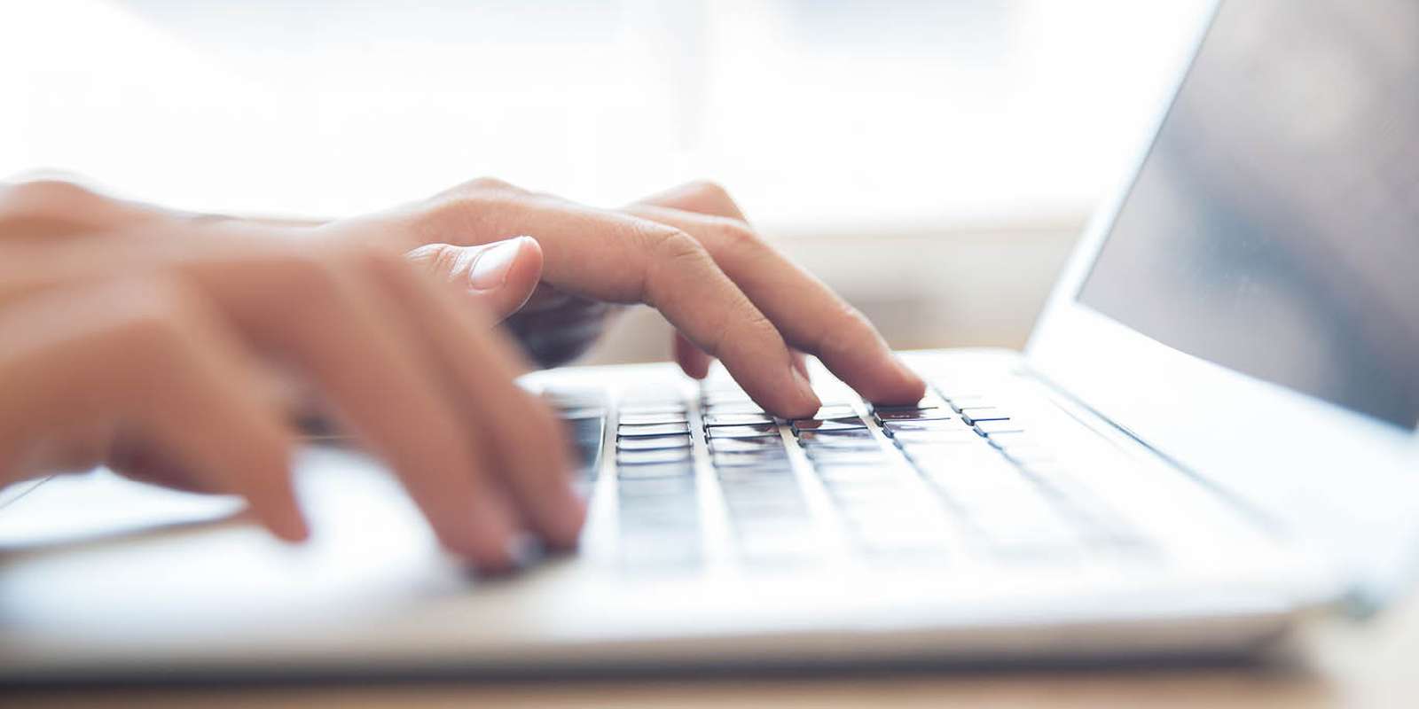 Student typing on laptop