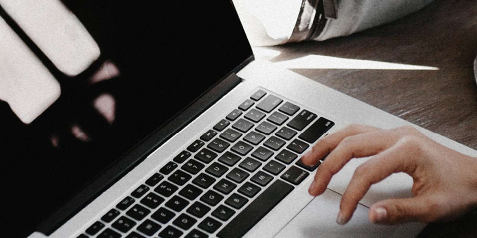 Woman with a coffee on a laptop