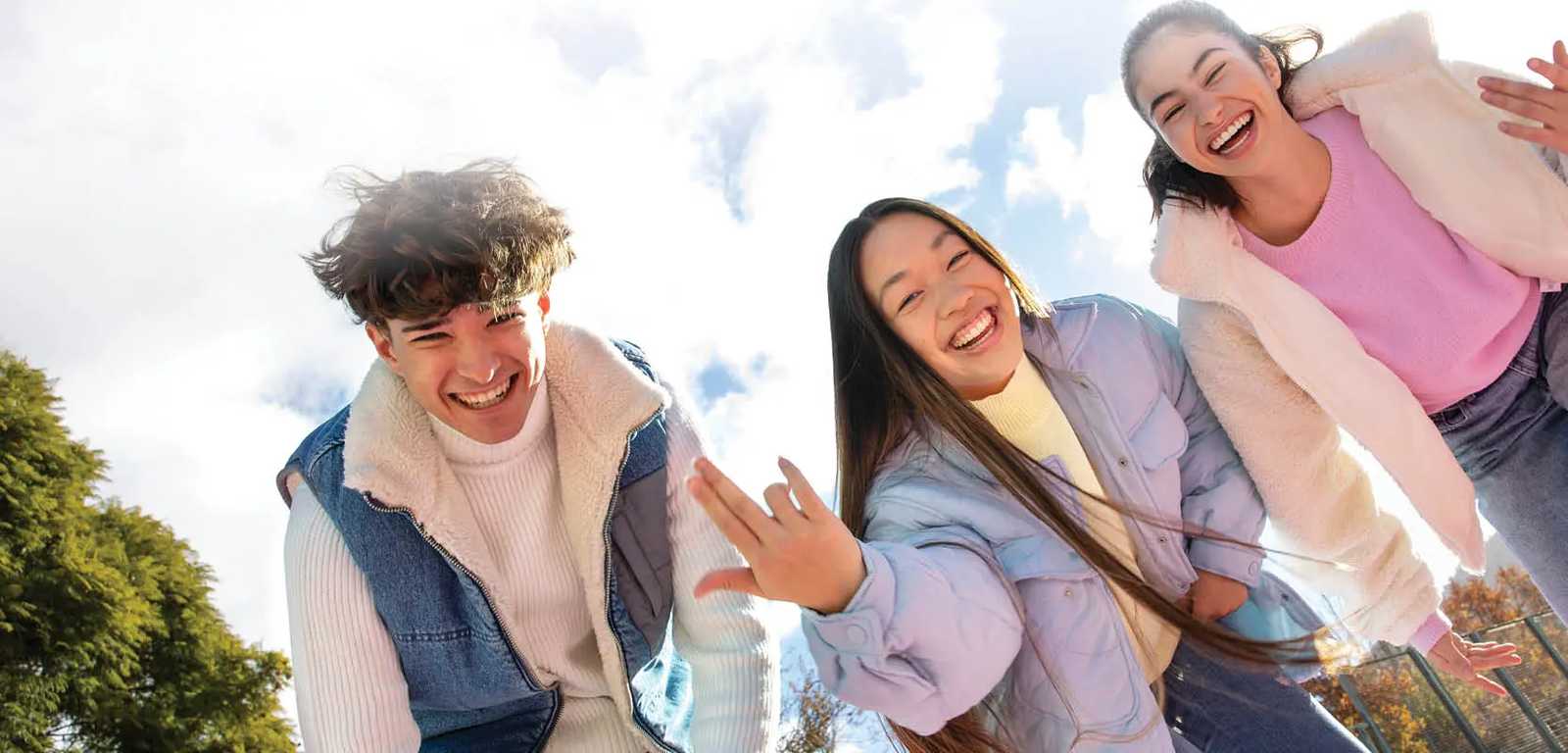 Happy smiling girls wearing jackets