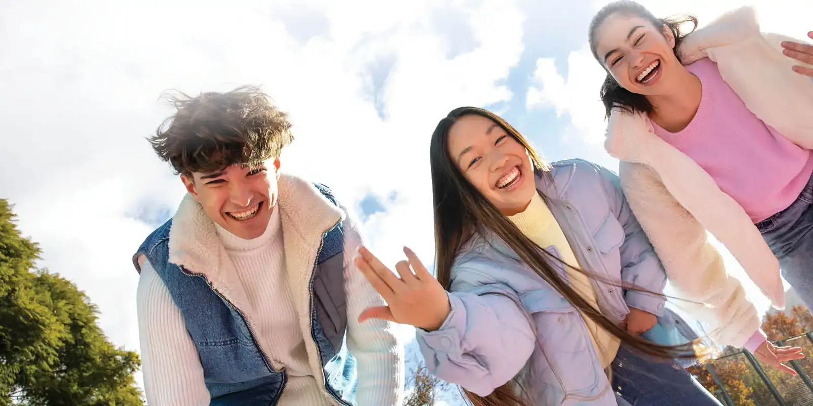 Happy smiling girls wearing jackets