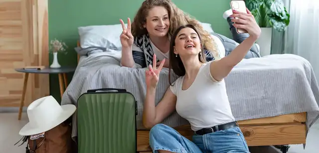 Two female friends taking a selfie on a phone