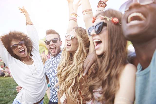 Smiling group of friends wearing sun glasses