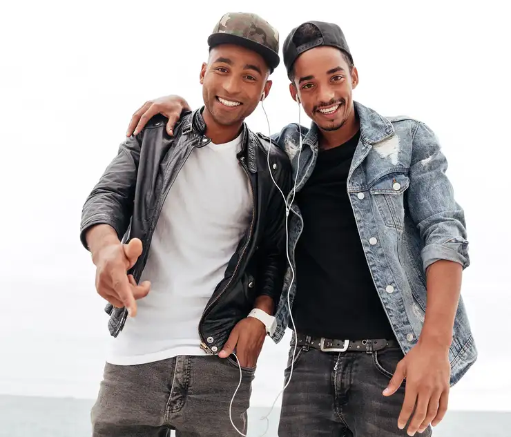 Two friends listening to music on headphones
