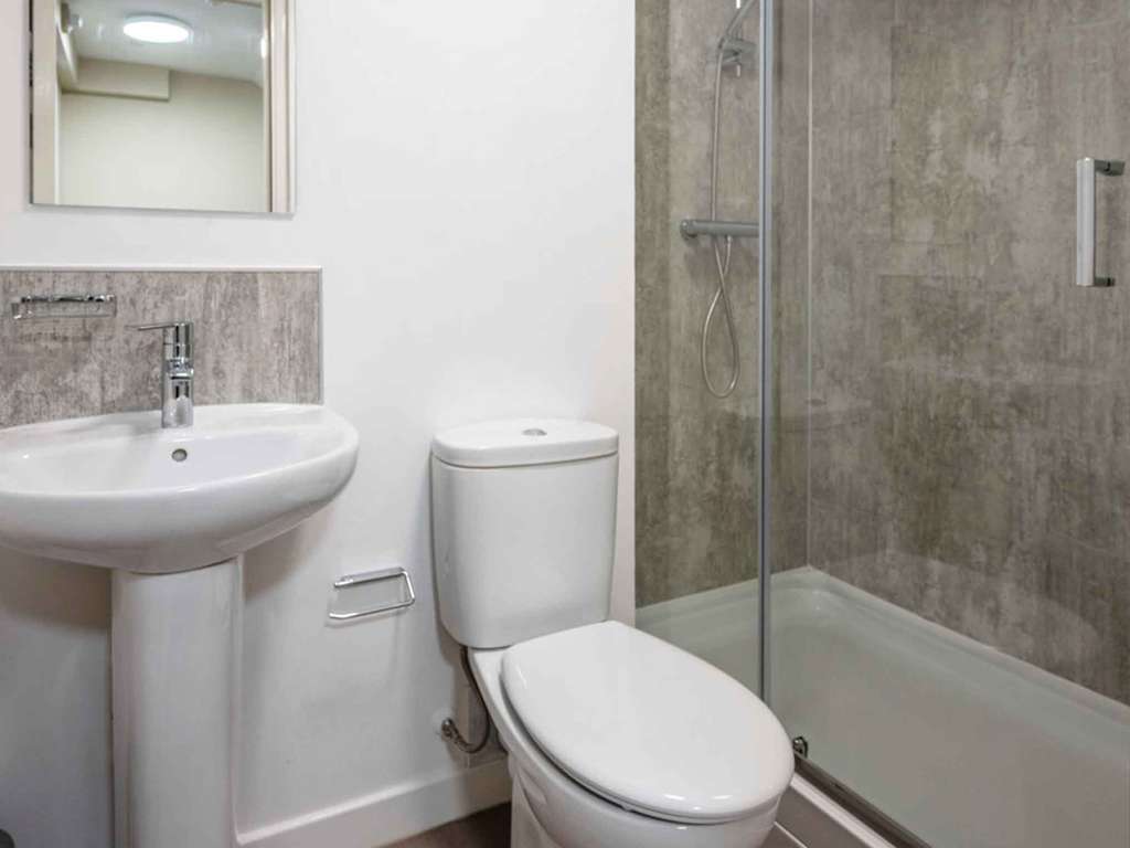 Ensuite bathroom including sink toilet and shower
