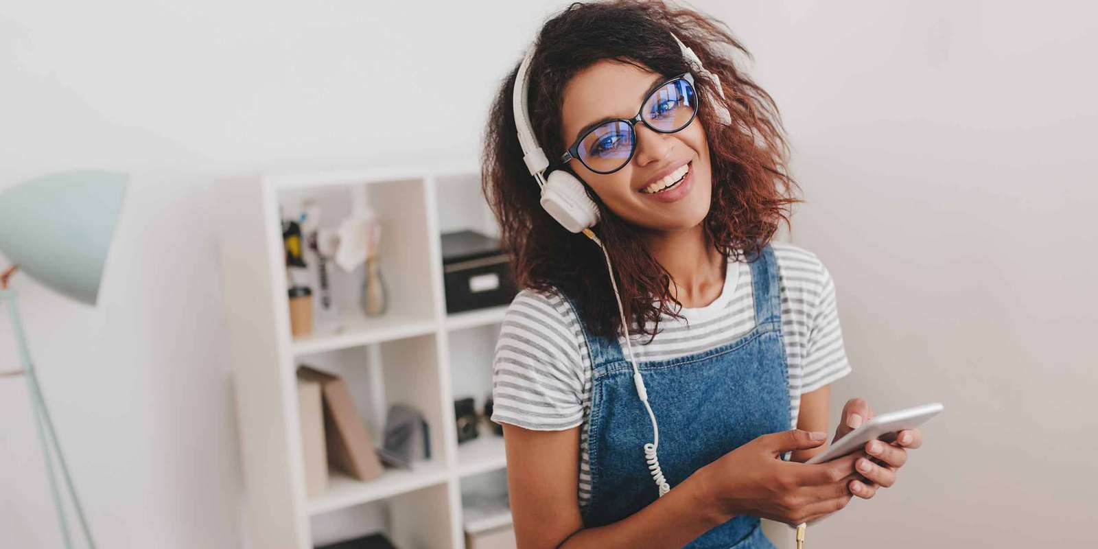 enthusiastic-girl-striped-shirt-listening-music-front-wall