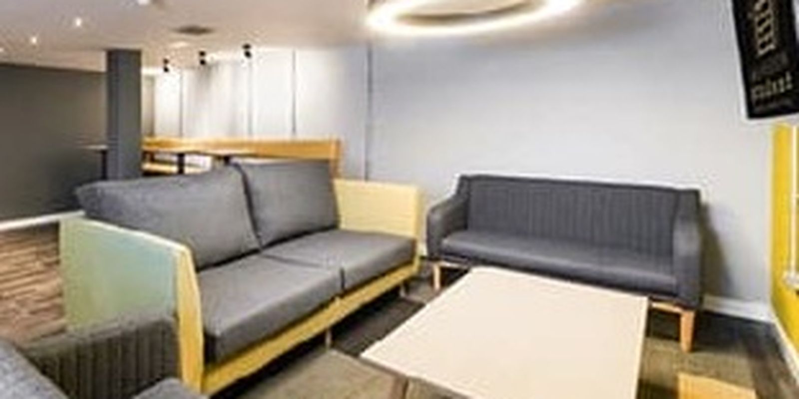 Student accommodation community area with tv and sofas