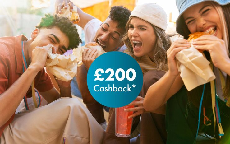Four friends laughing and eating wrapped food outdoors, with a £200 cashback offer prominently displayed in the foreground.