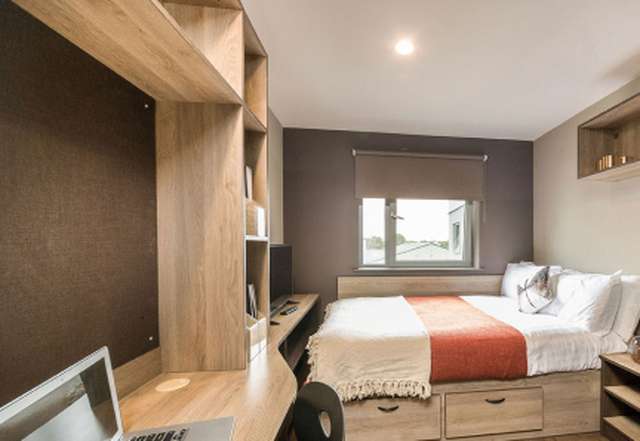 Student bedroom with desk and laptop