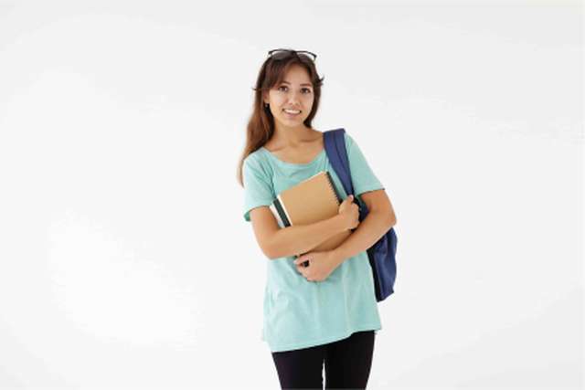 Student holding books and notepads