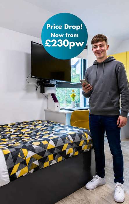 A smiling person in a hoodie stands in a modern, colorful room with a "Price Drop! Now from £230pw" notice.