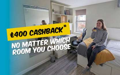 A person sits on a bed in a cozy room holding a mug. Text offers £400 cashback "no matter which room you choose."