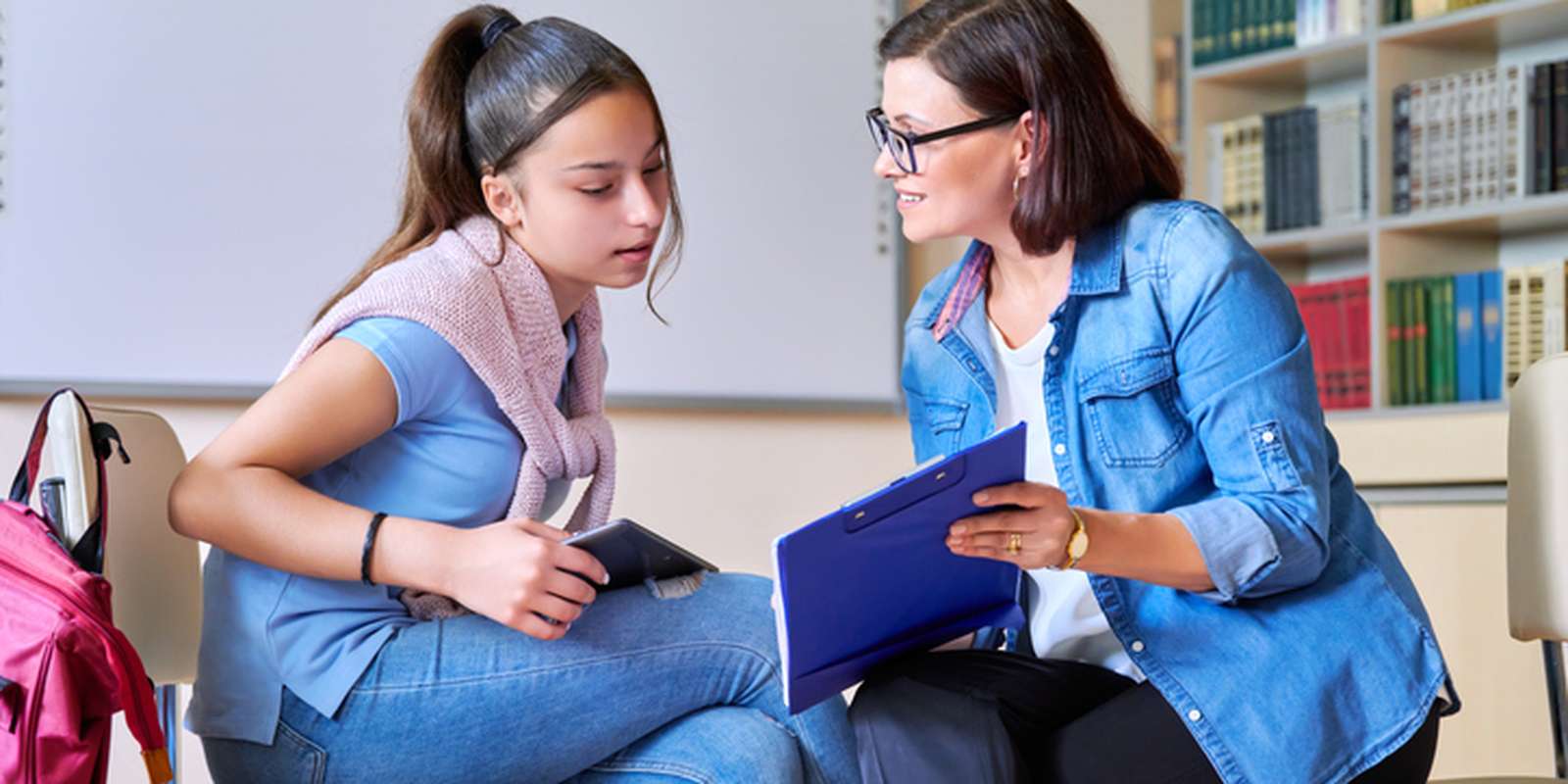 Psychologist teacher talking and helping student