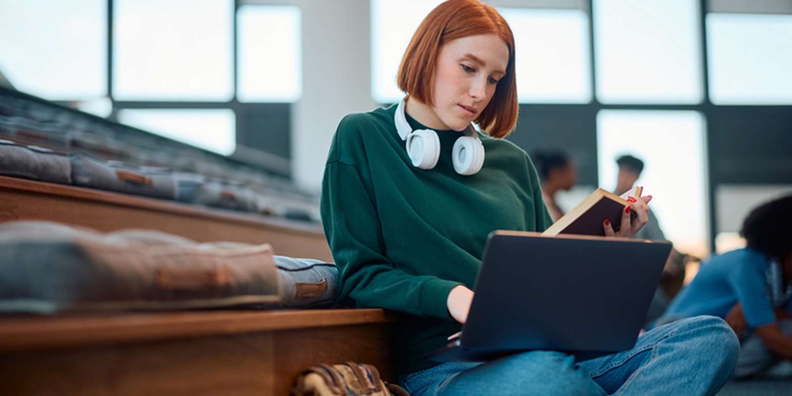 University student using her laptop while learning in lecture hall