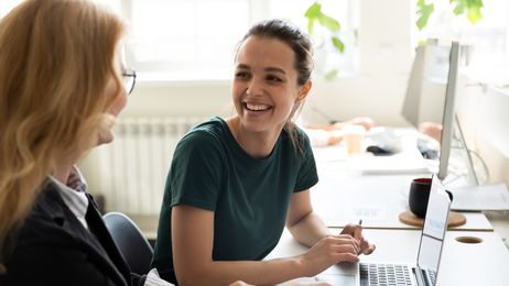 female trainee discussing business ideas with adult trainer
