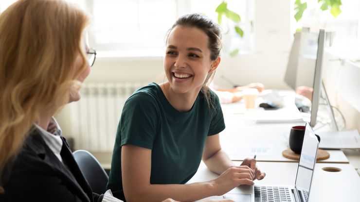 female trainee discussing business ideas with adult trainer