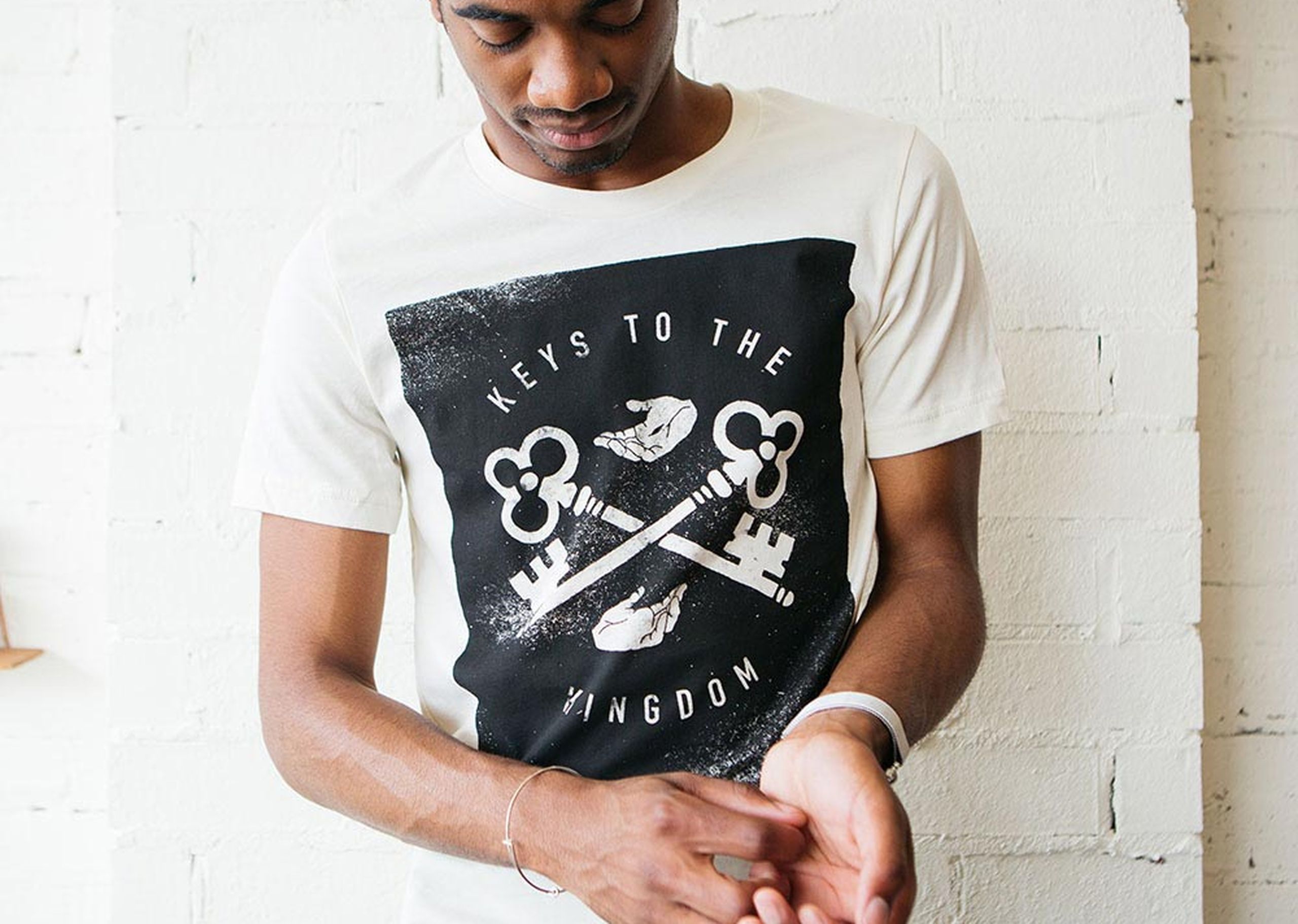 A man wears a shirt that says "keys to the kingdom," a custom church shirt 