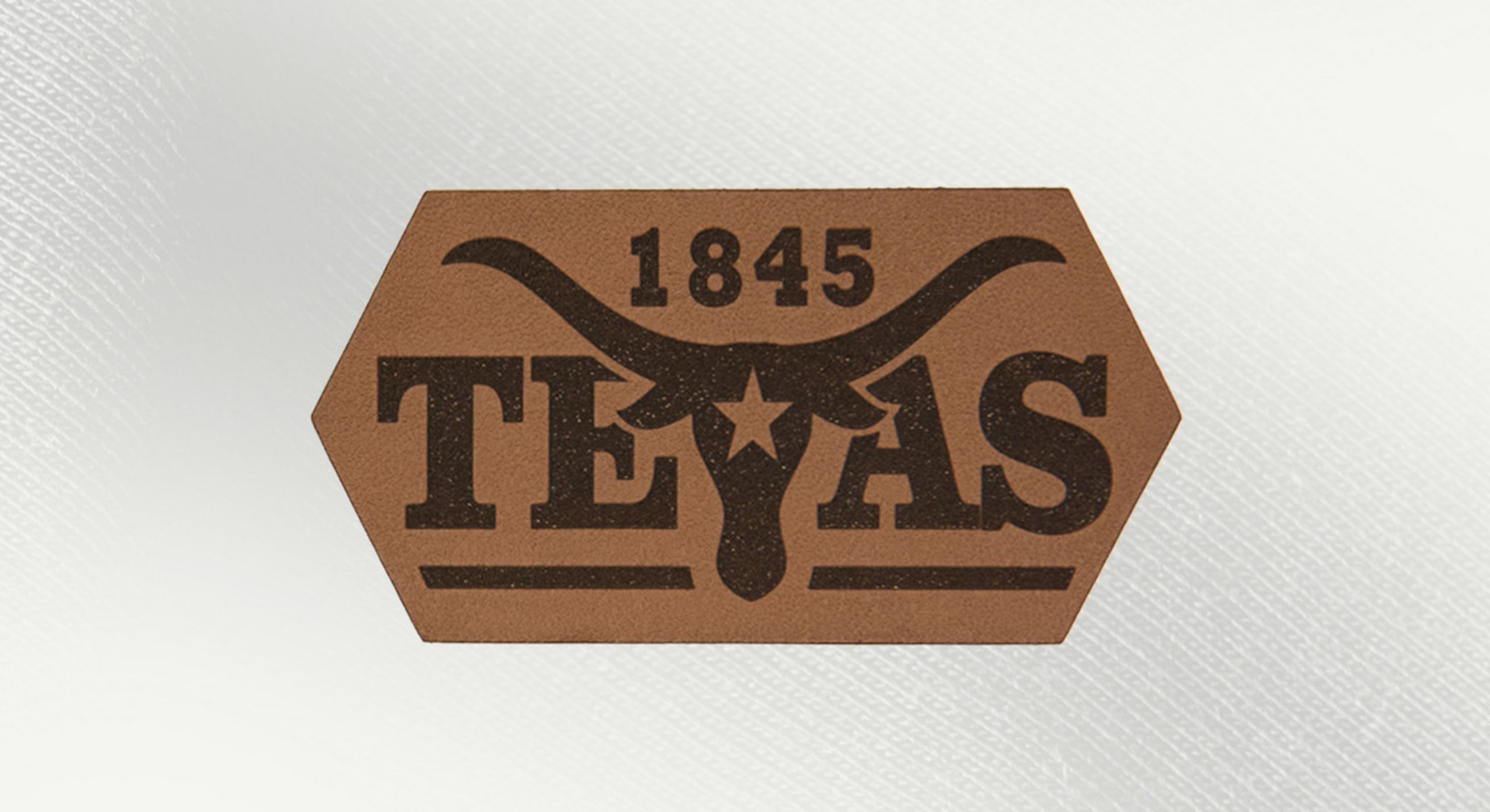 a caramel leather patch with a texas longhorn and the word texas