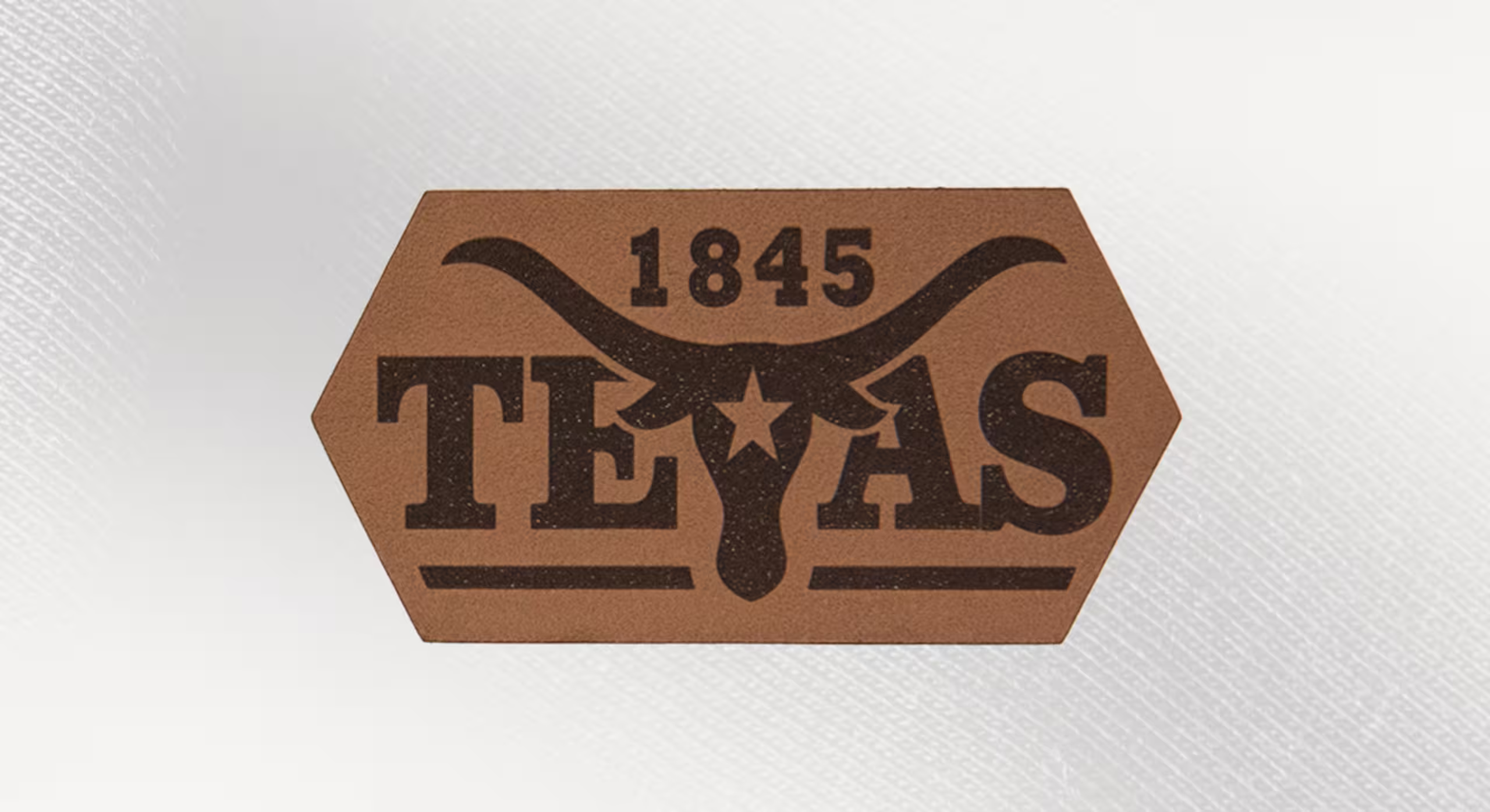 a caramel leather patch with a texas longhorn and the word texas