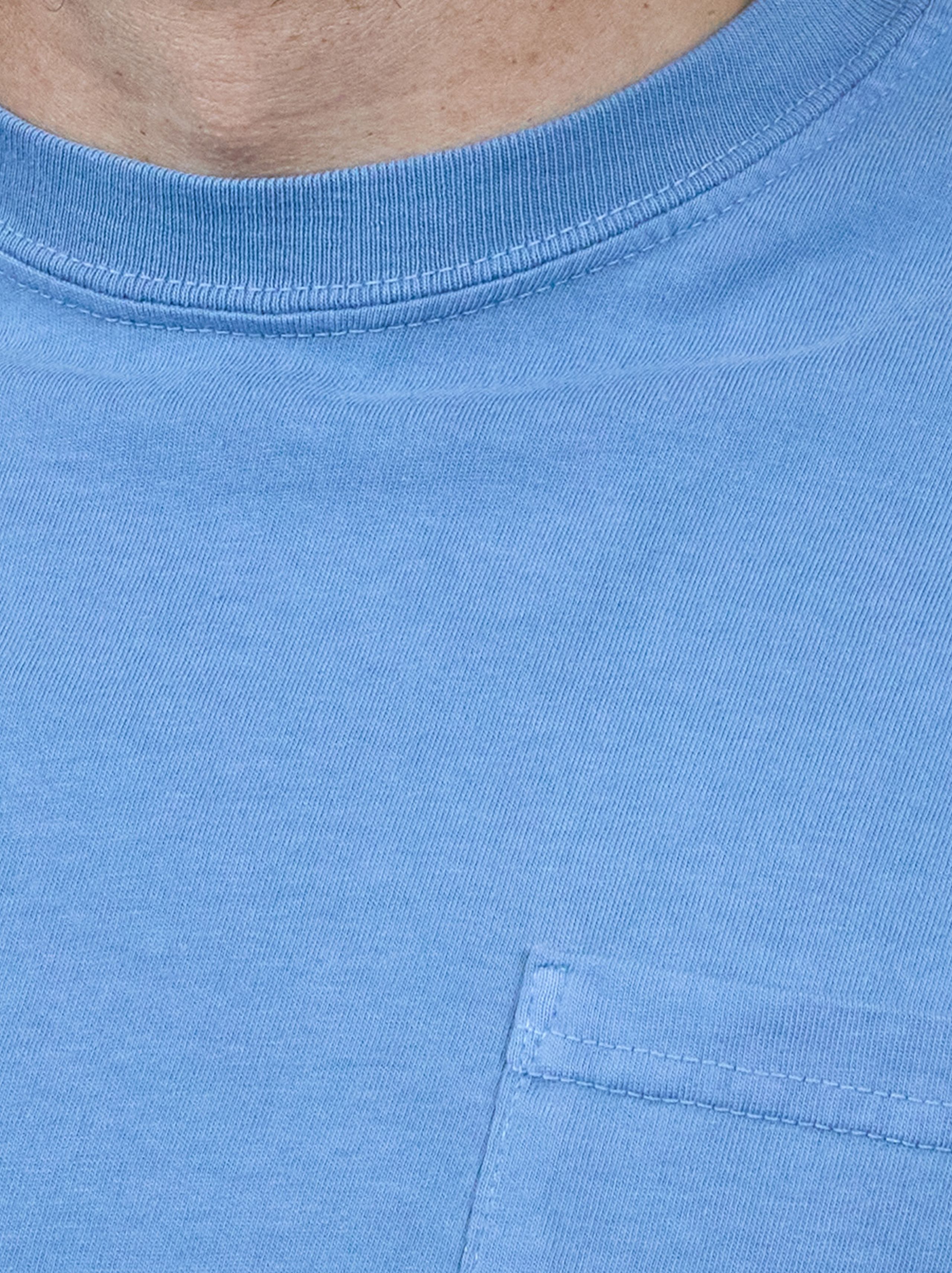 Close-up of a person wearing a blue T-shirt with a visible pocket and ribbed neckline.