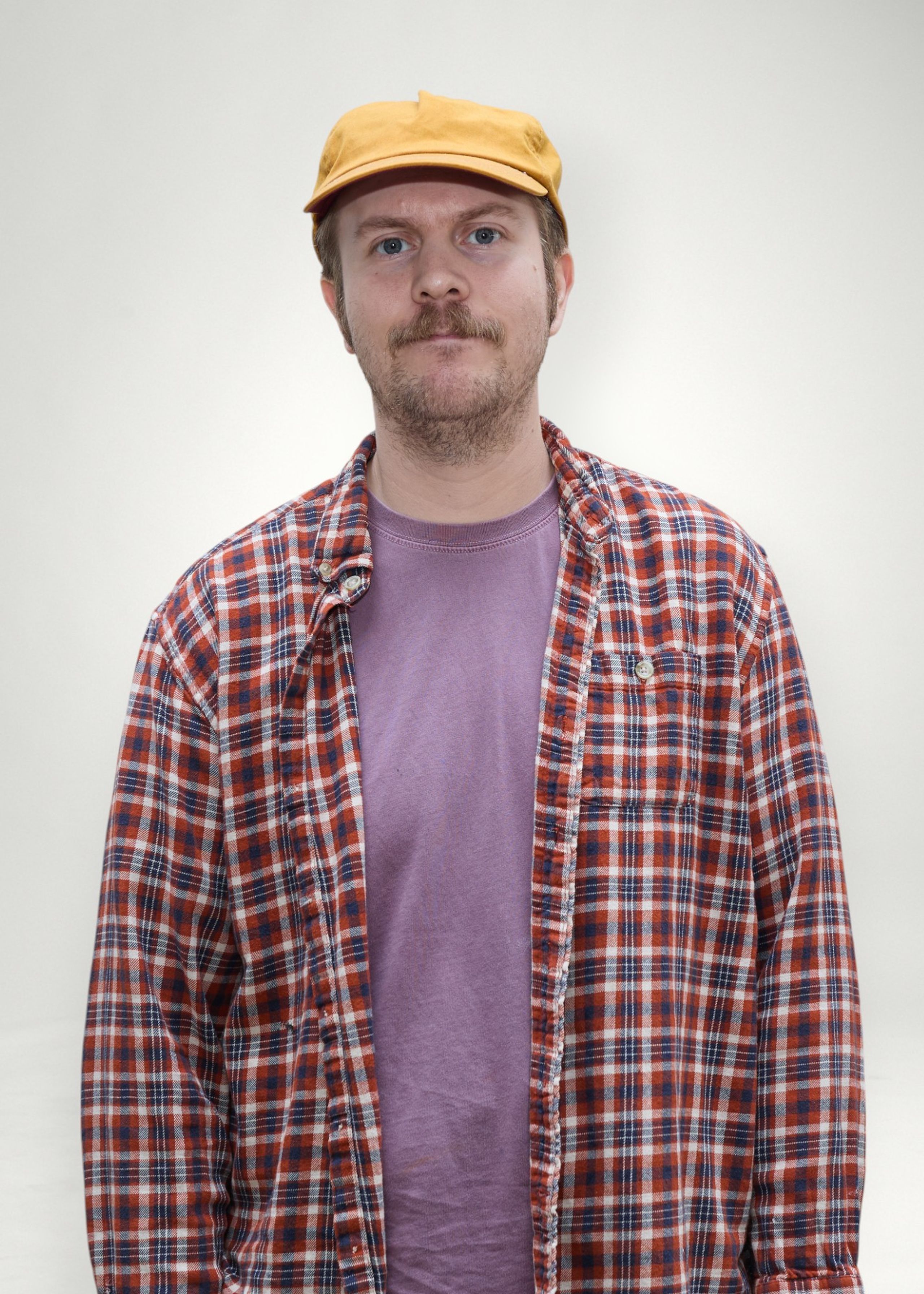 Matt poses in front of white background