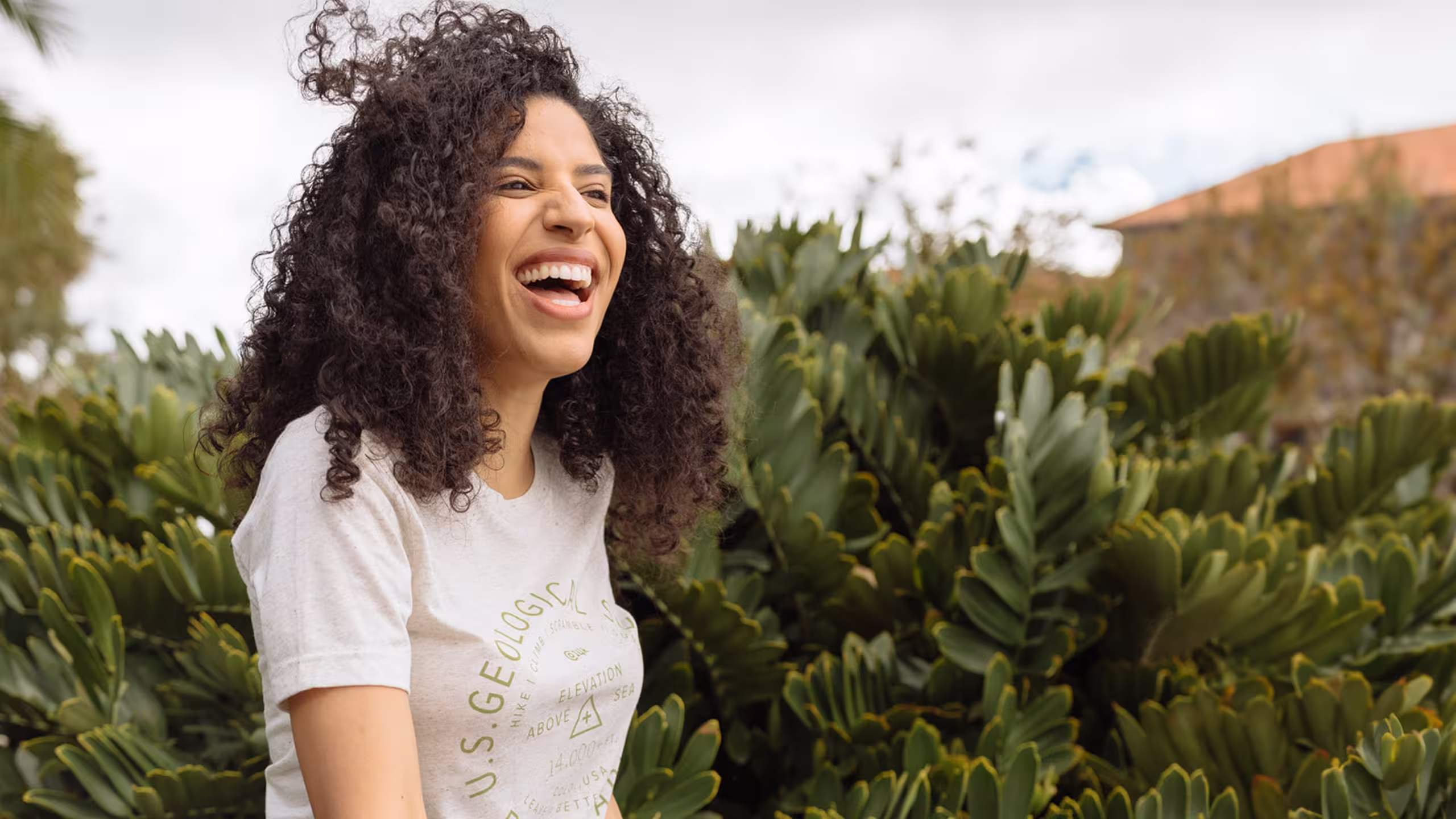 women wearing white shirt in front of tropical plants