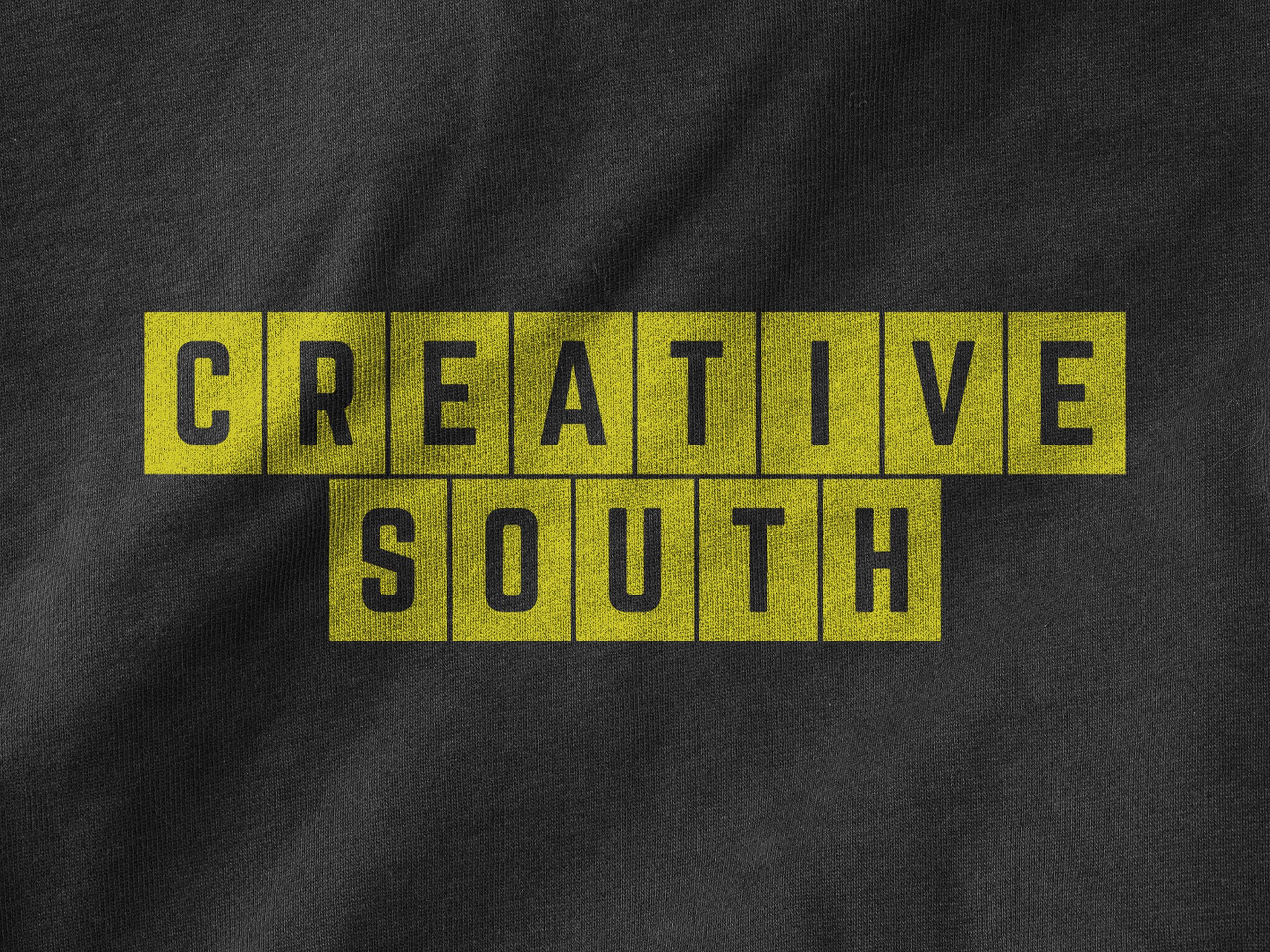 yellow creative south 2025 logo on t-shirt fabric texture