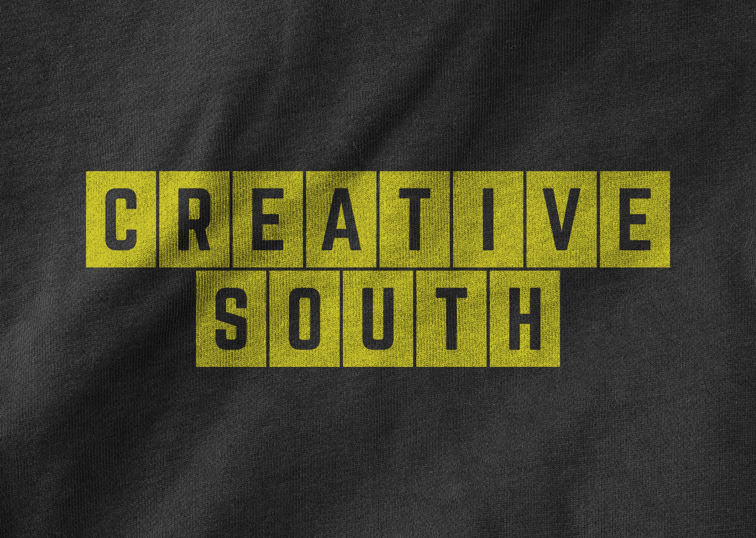 yellow creative south 2025 logo on t-shirt fabric texture