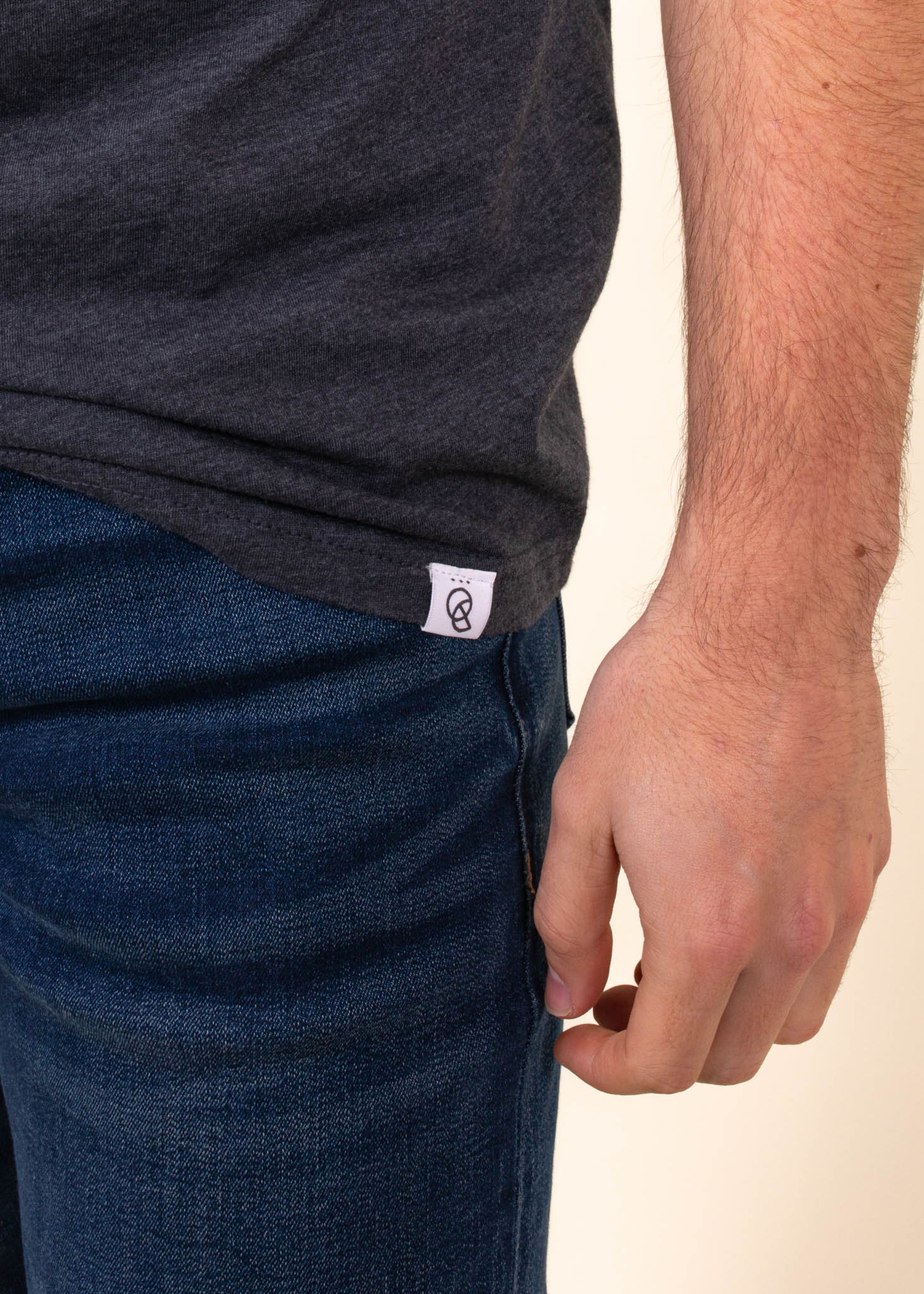 A custom hem tag is being worn on a man with jeans 