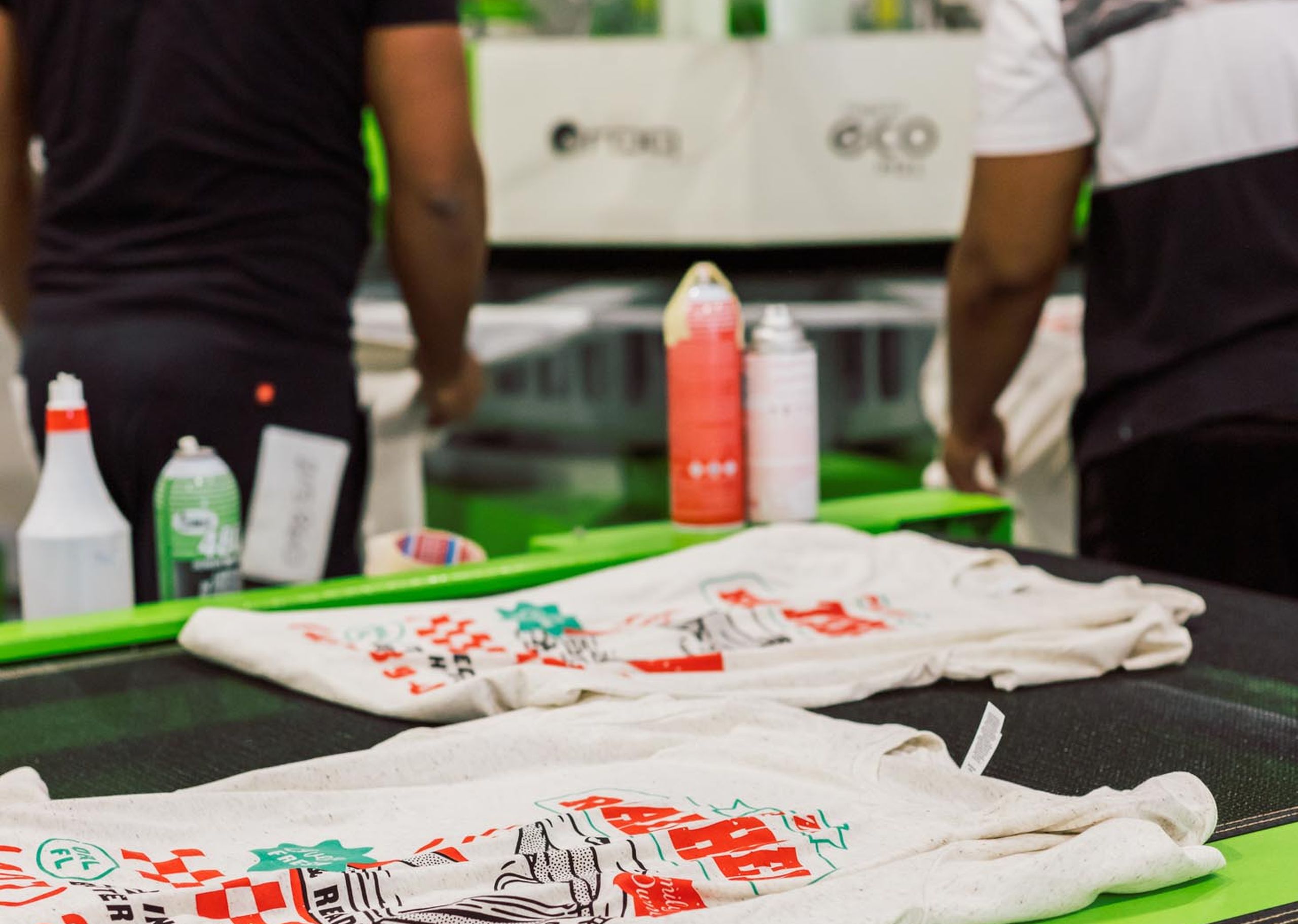 white shirts with a pizza design laying on the t-shirt dryer