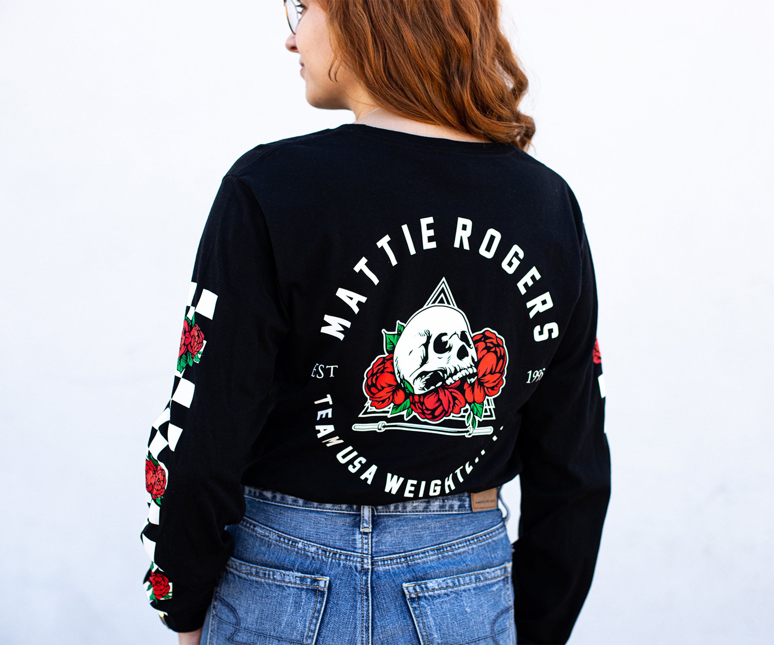 the back of a women wearing a long sleeve t-shirt